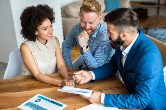 Group of people looking at charts and working together